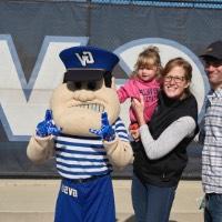 Dad, mom, and daughter smile with Louie